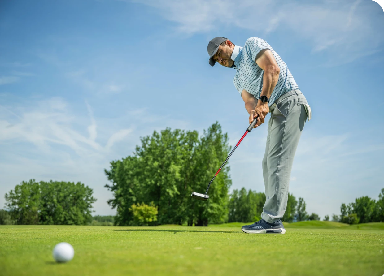 Person focusing on golf shot outdoors
